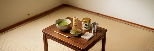 A complete matcha set laid out with a chawan bowl, bamboo whisk, scoop, holder, and sifter.